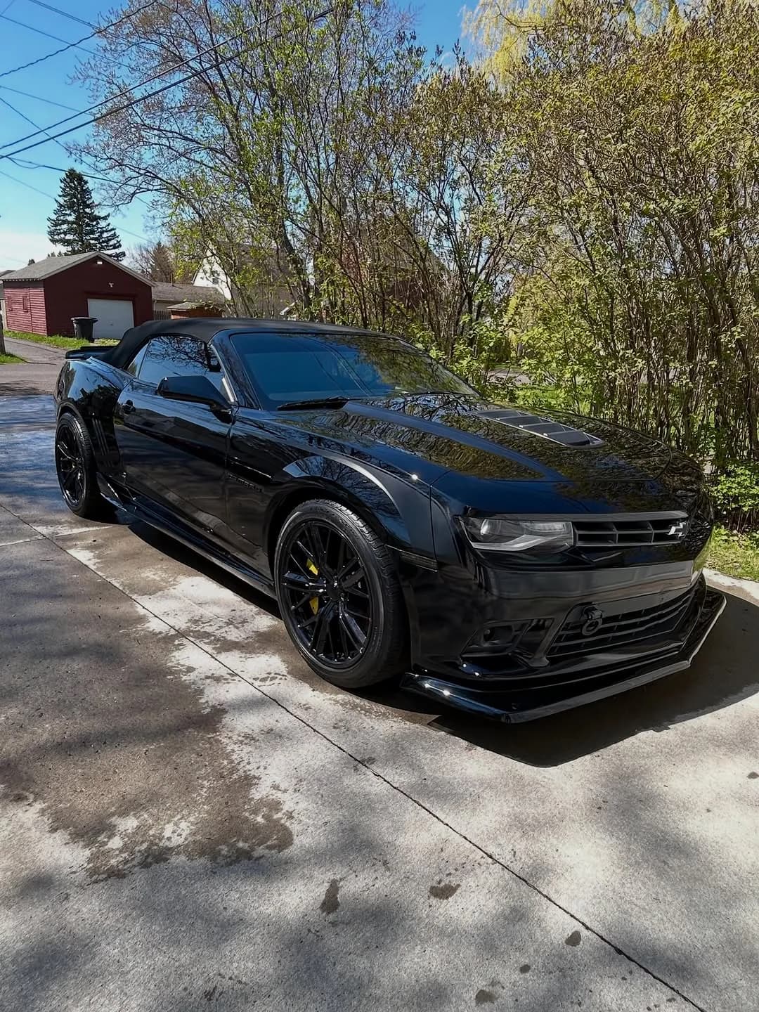 Side view of a black Camaro SS after correction and ceramic coating