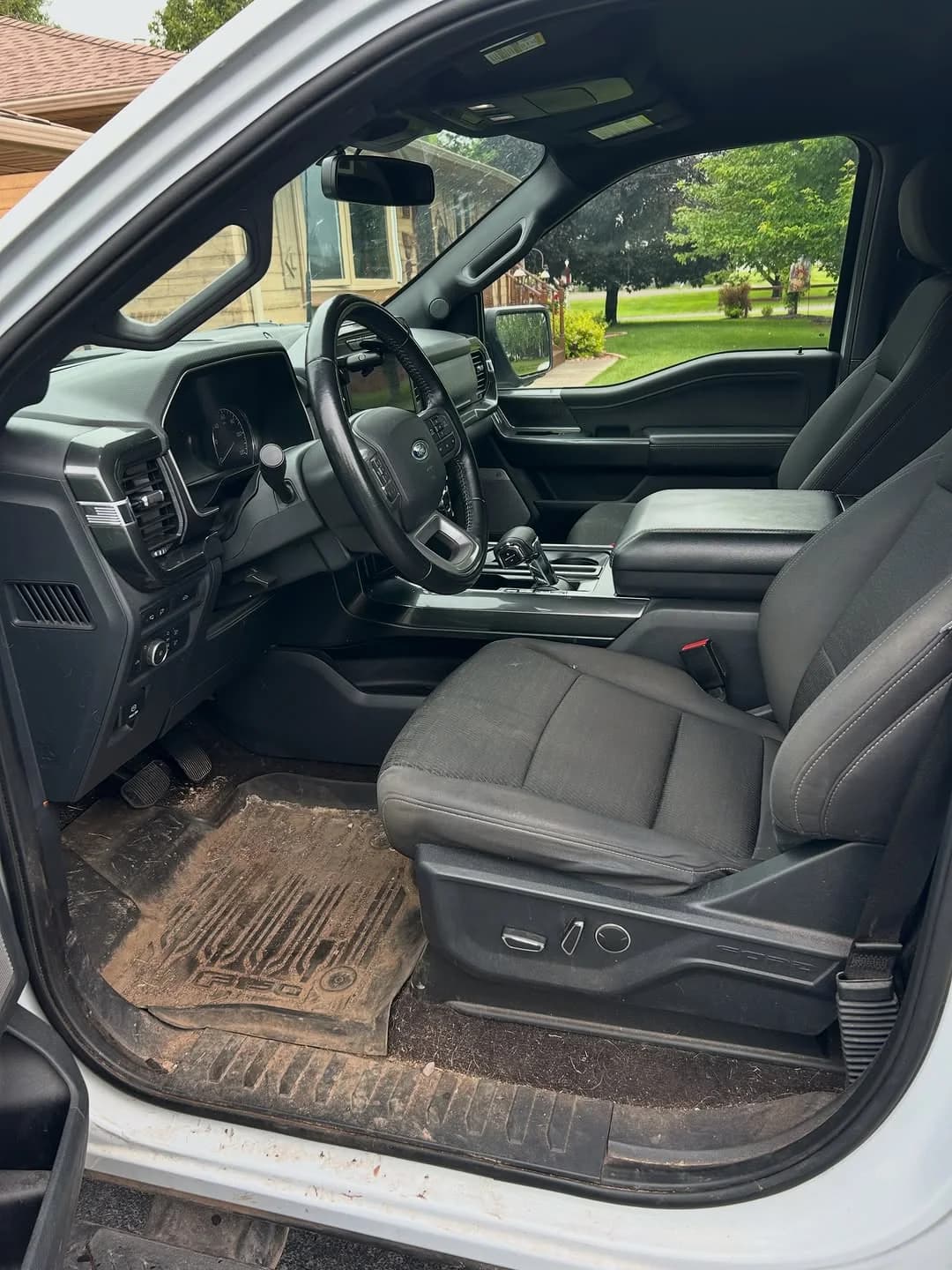 Ford F-150 cabin with tracked-in dirt before interior detailing